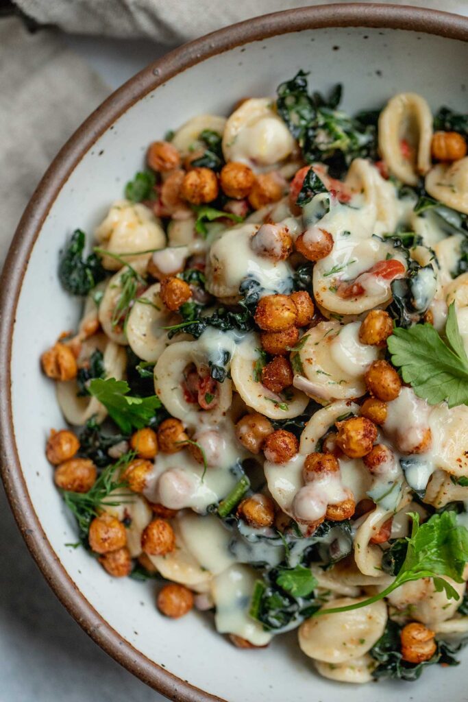 Pasta salad topped with roasted chickpeas and maple mustard dressing.