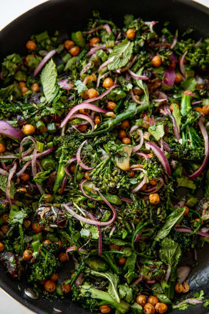 Fully mixed broccolini date salad in a pan.
