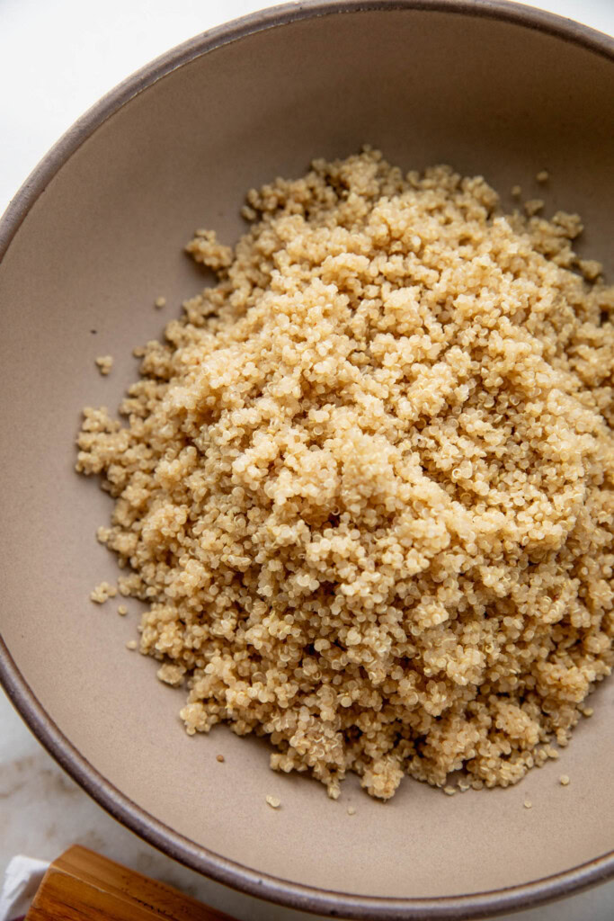 Large mixing bowl with fluffy quinoa in it.