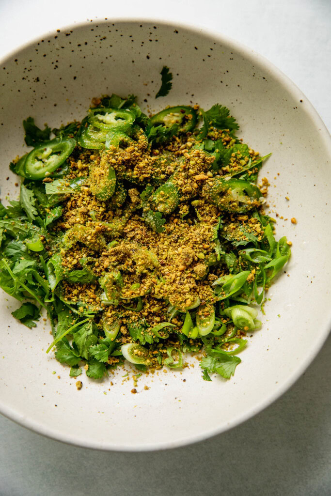 Scallion and cilantro salad ingredients in a white bowl.