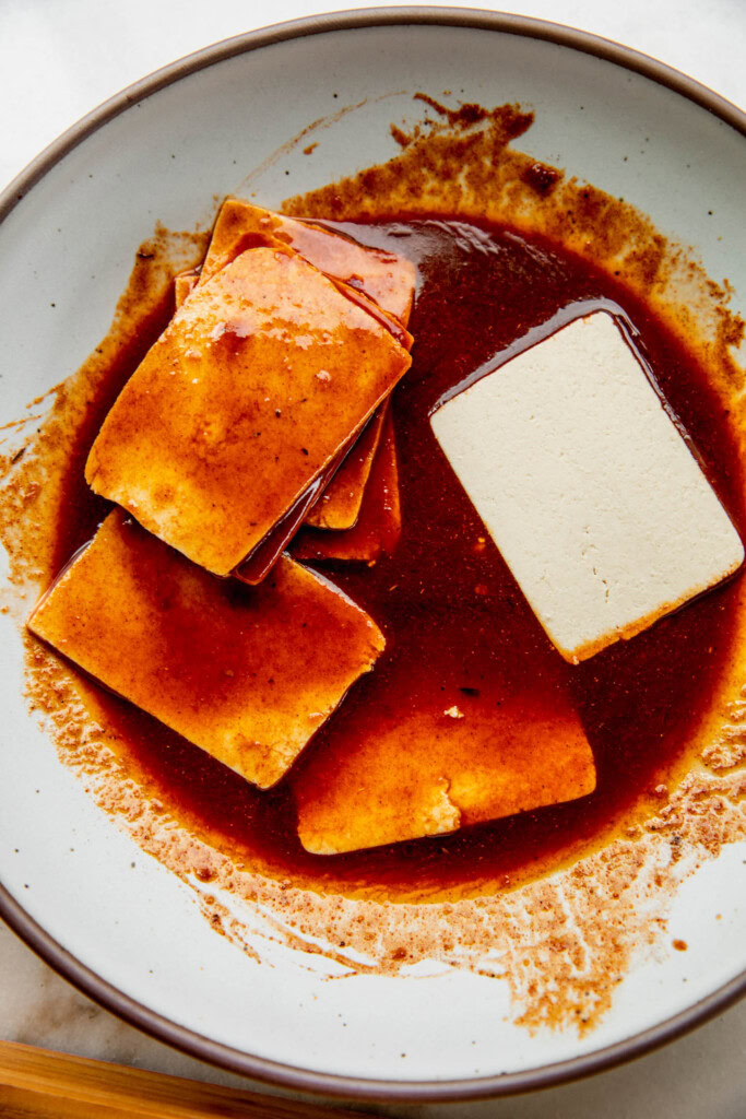 Marinating the tofu slices in a chipotle sauce.