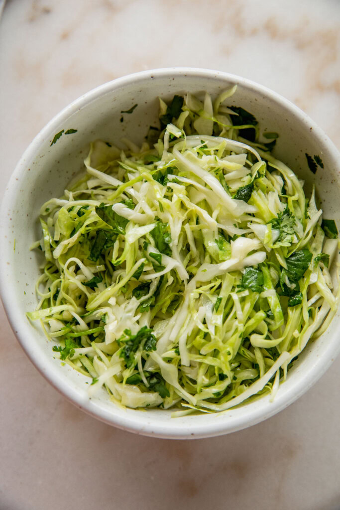 Mixed cabbage slaw in a bowl.