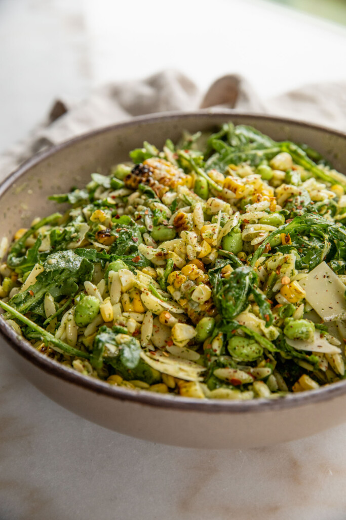 Grilled corn mixed with orzo, arugula, and a scallion dill salad.