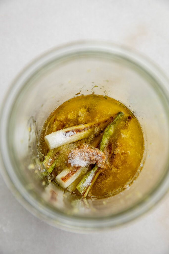 Blending the scallion dressing together in a blender cup.