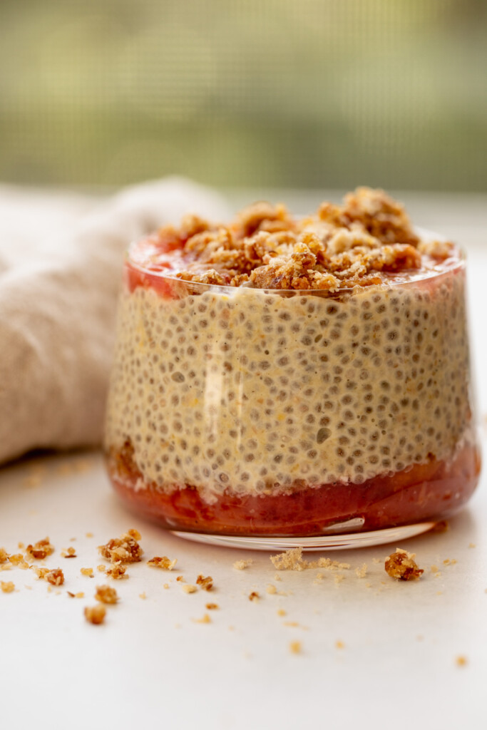 Cup layered with cooked peaches, chia pudding, and the cobbler crumb.