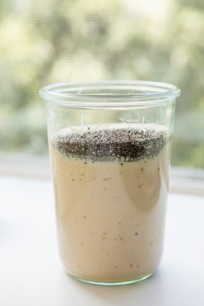 Adding the chia seeds to the peach milk mixture.