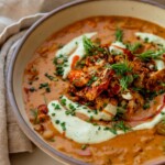 Bowl filled with buffalo cauliflower soup and topped with extra roasted cauliflower and a drizzle of cashew cream.