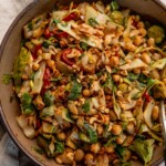 Close up of a mixing bowl filled with a dan dan bean salad.
