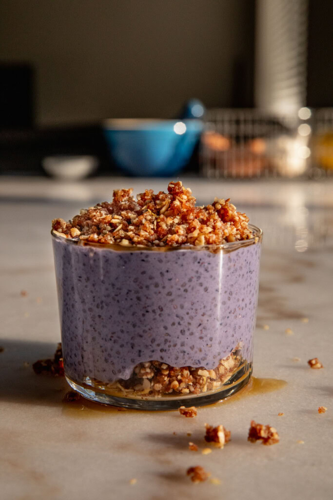 A cup layered with crumble and blueberry chia pudding.