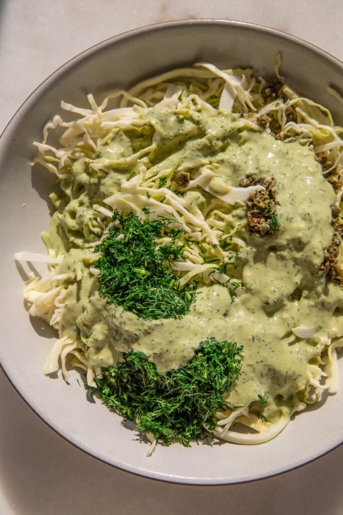 Cabbage topped with dill, capers, and a lemon dill dressing.