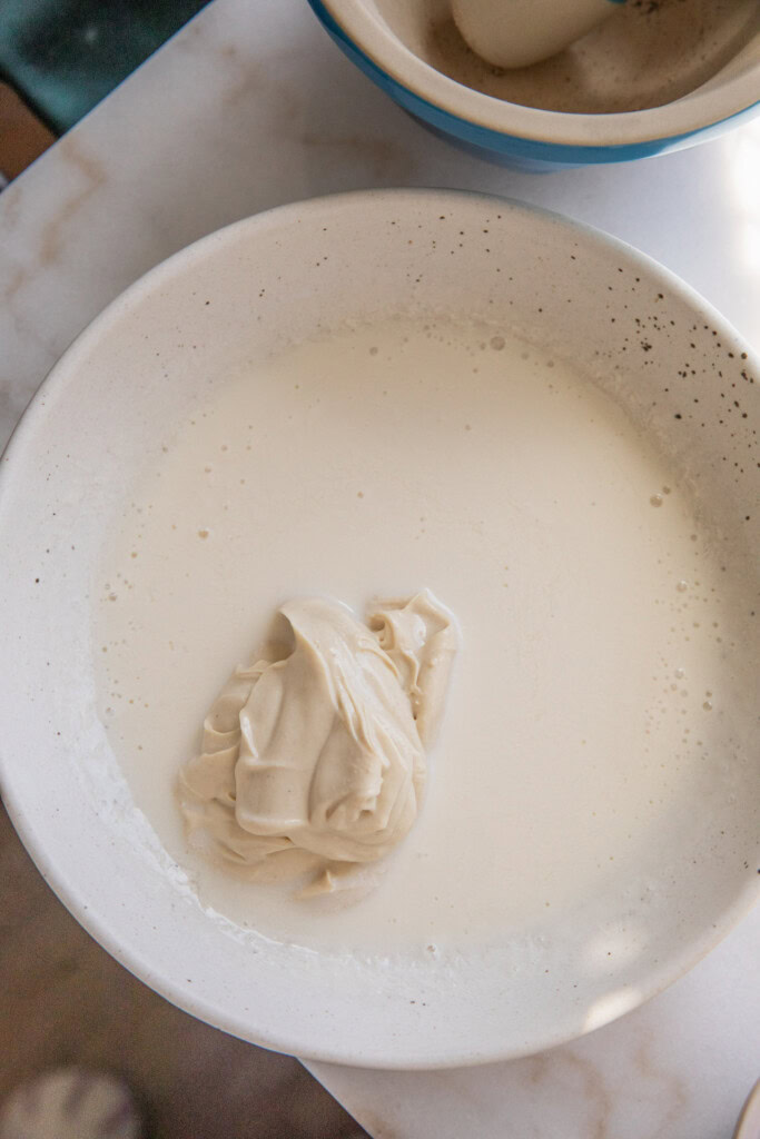Mixing the yogurt and buttermilk together in a bowl.