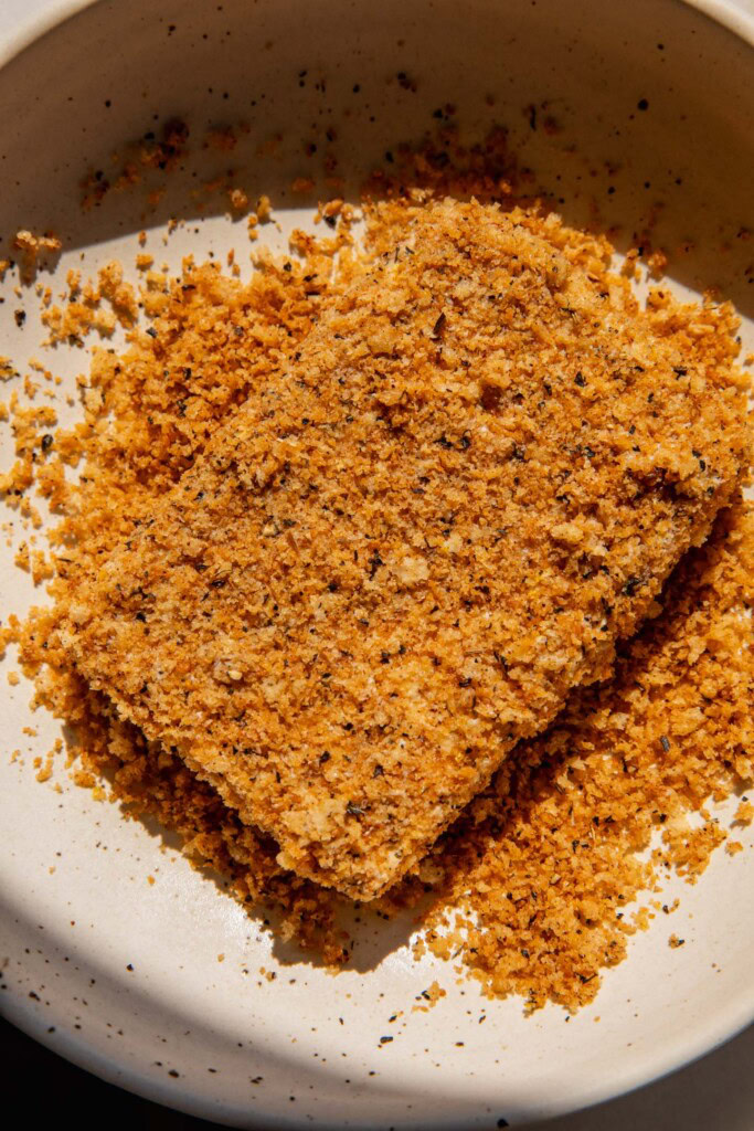 Coating the tofu in toasted panko.
