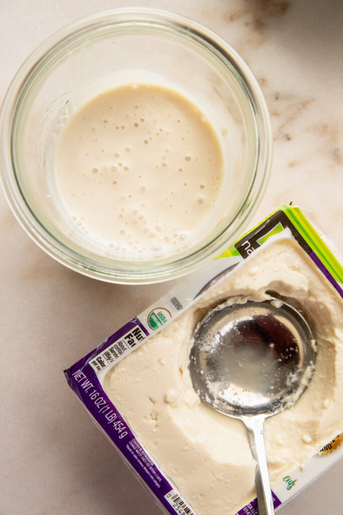 Blended silken tofu in a blender cup.