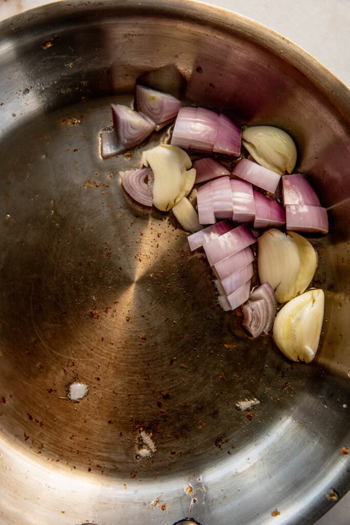 Cooking shallots and garlic in a pan.
