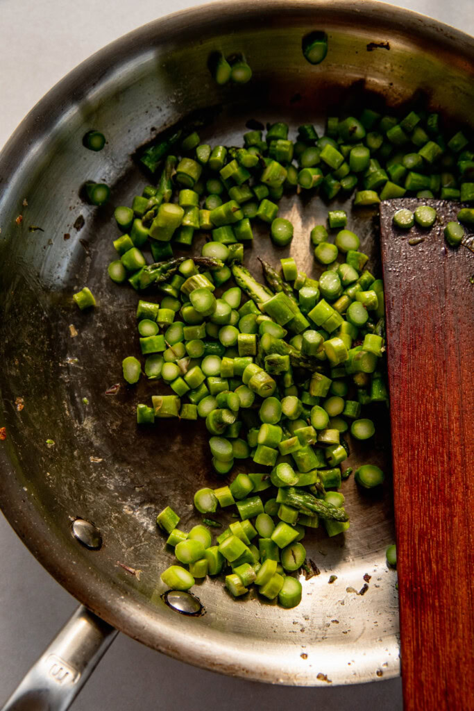Cooking the asparagus in a pan.