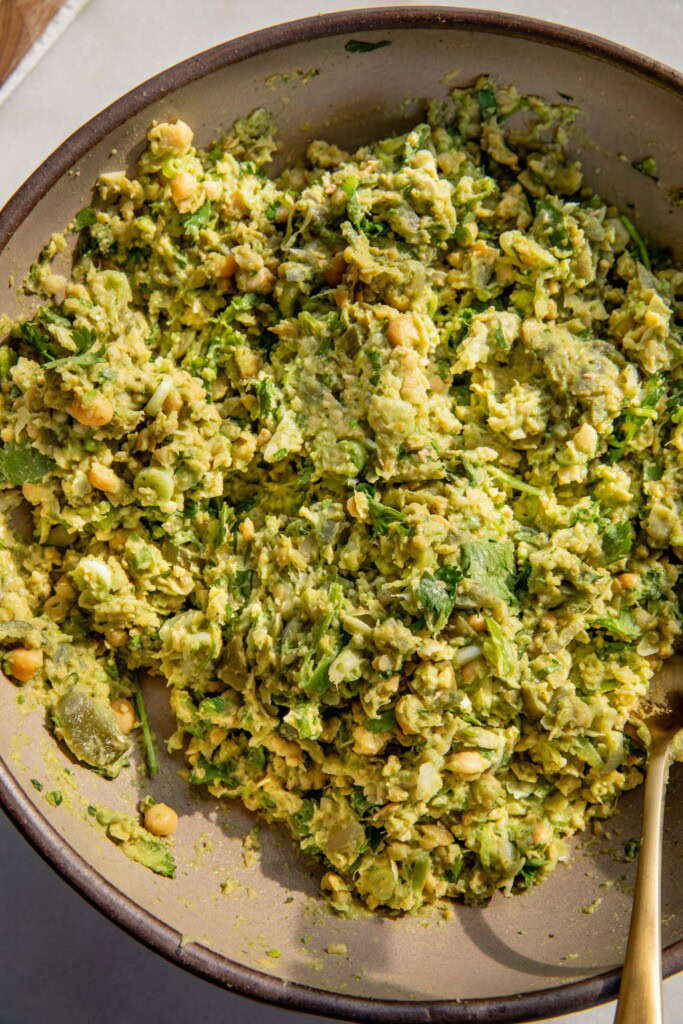Mixing the zhug inspired dressing with the chickpea filling.