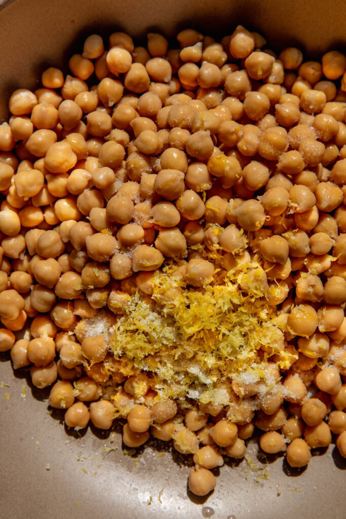 Bowl with lemon zest, chickpeas and salt.