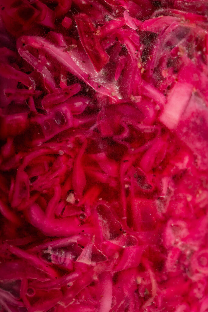 Close up of the jar of marinated red cabbage slaw from the side.