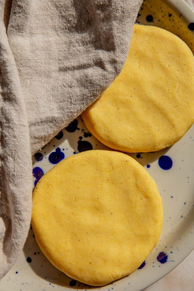 Arepa disks on a plate.