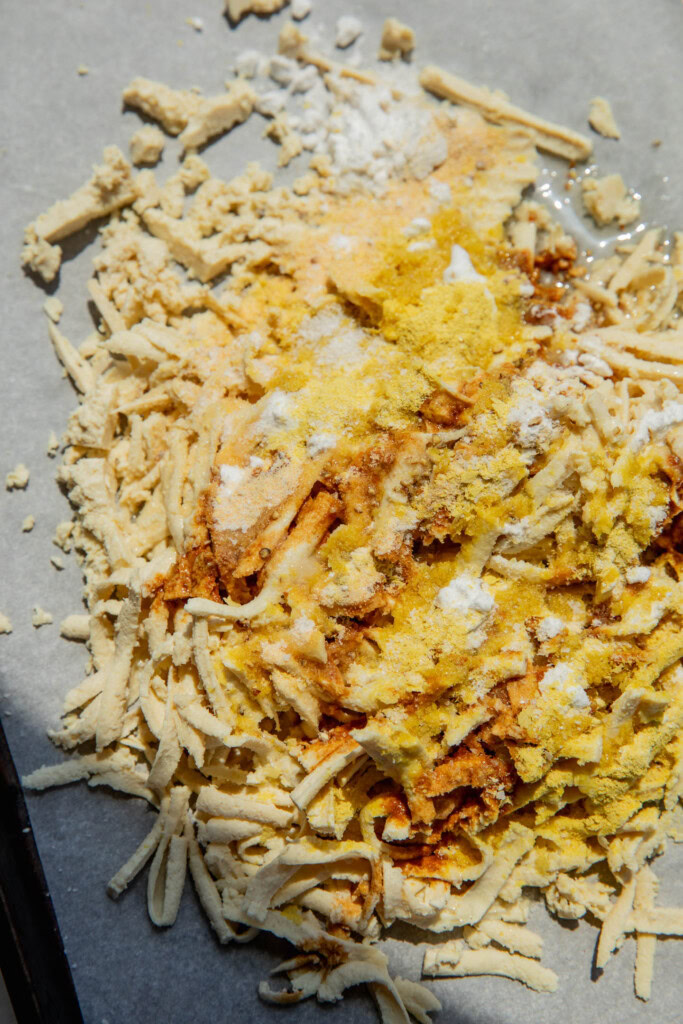 Tamari, nutritional yeast, potato starch, and garlic powder covering the tofu shreds.