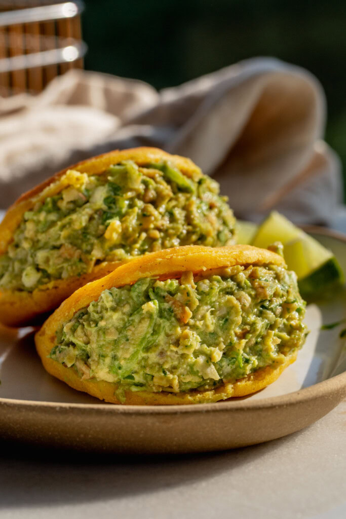 Close up of the arepas stuffed with the green guasacaca and tofu salad.