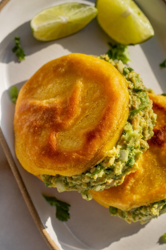 Top down close up of the stuffed arepas with guasacaca.