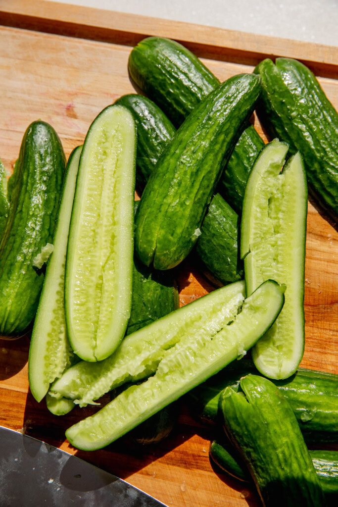 Smashed cucumbers on a cutting board.