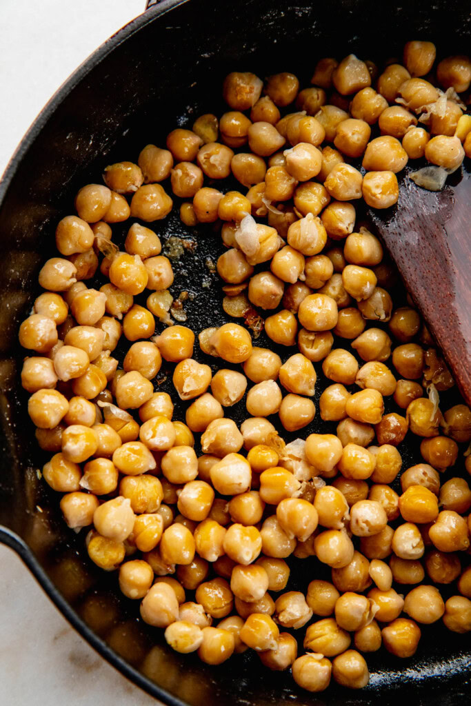 Chickpeas golden after sauteing in a pan.