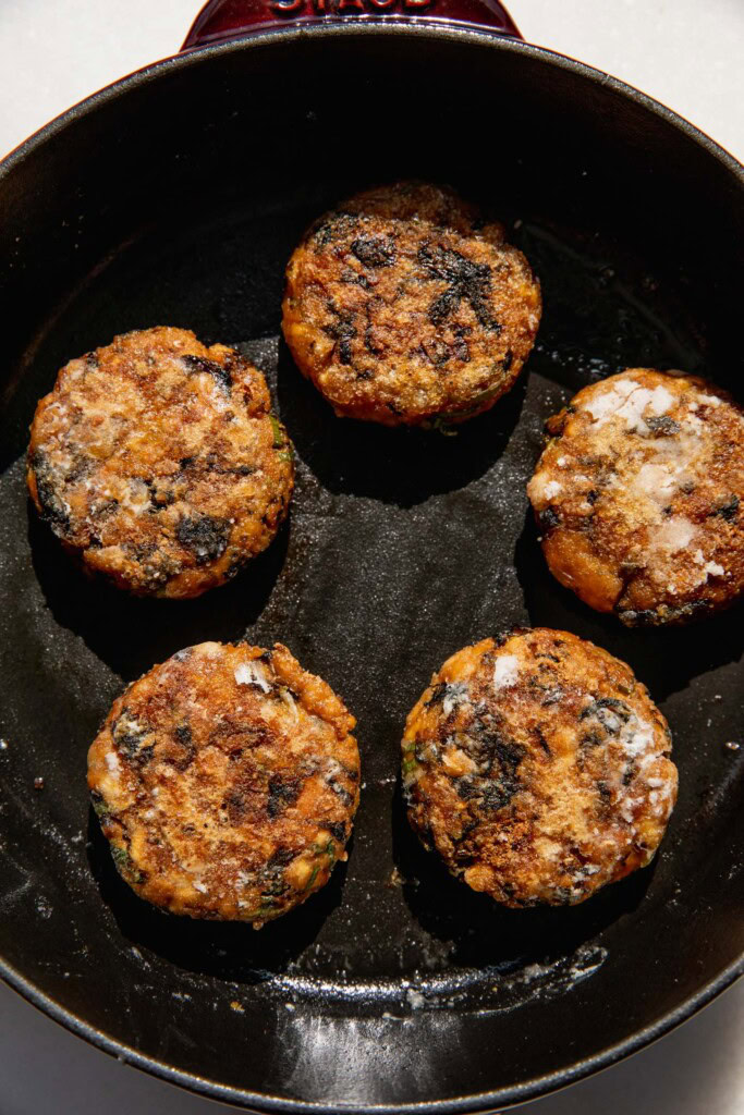 Cooked tofu patties in a pan.