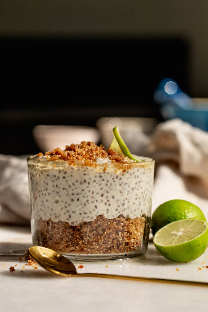 Chia pudding layered between graham cracker crumbs and a slice of key lime on top.