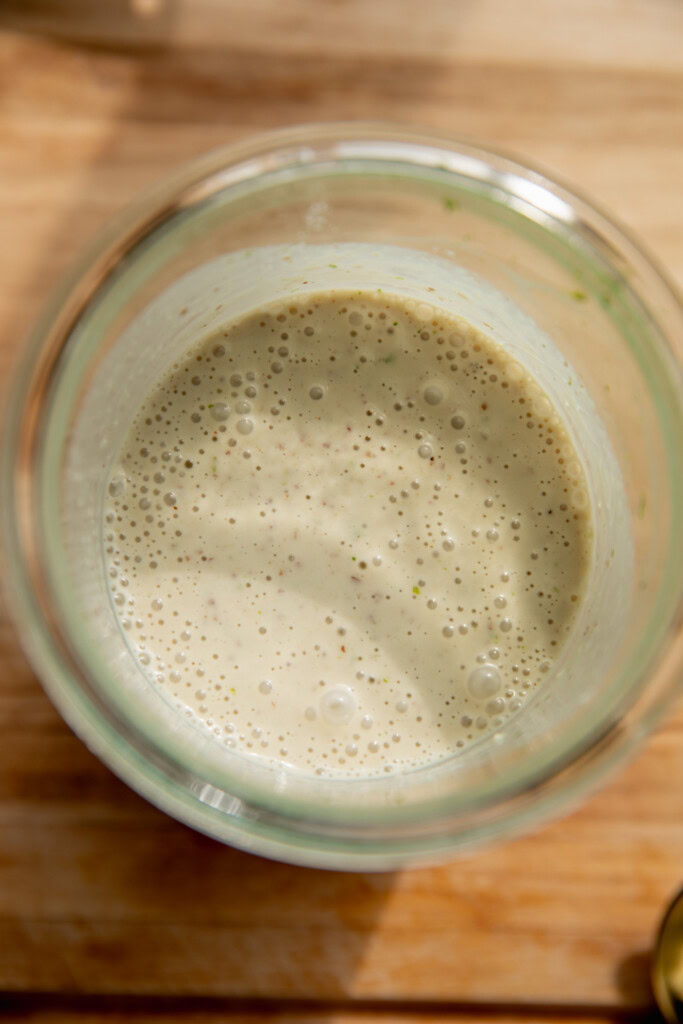 Creamy blended key lime cheesecake milk in a jar.
