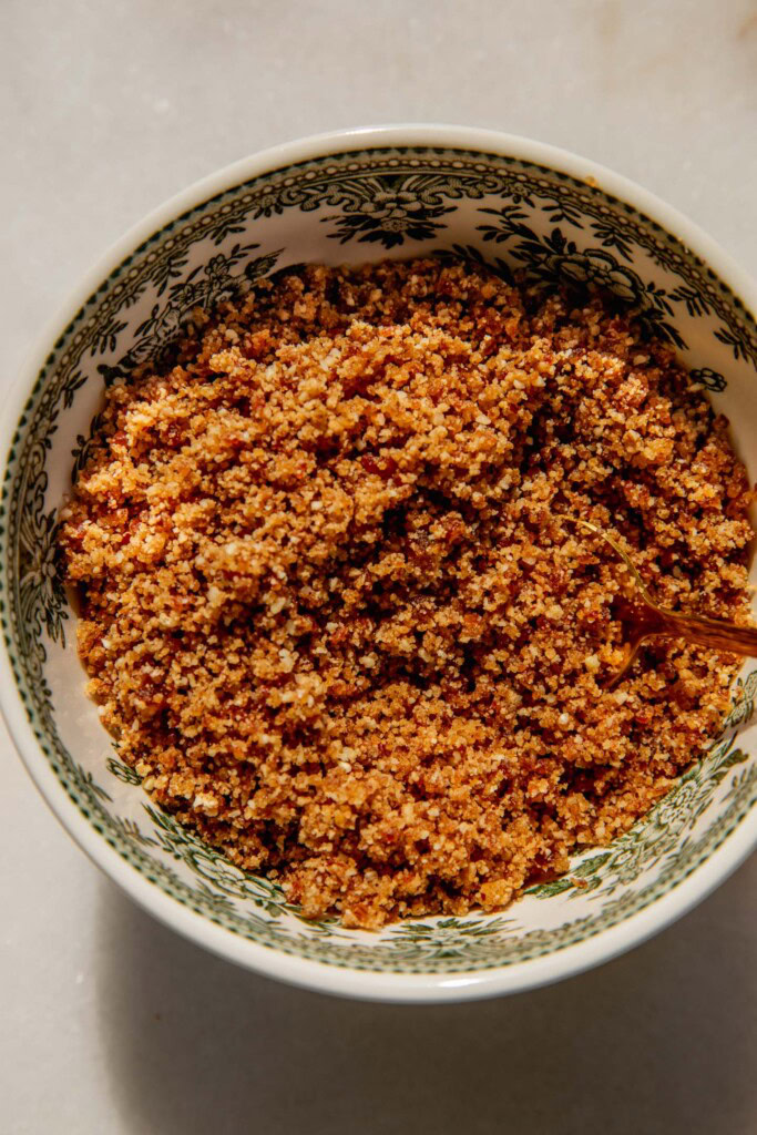 The blitzed graham cracker crumb in a bowl.