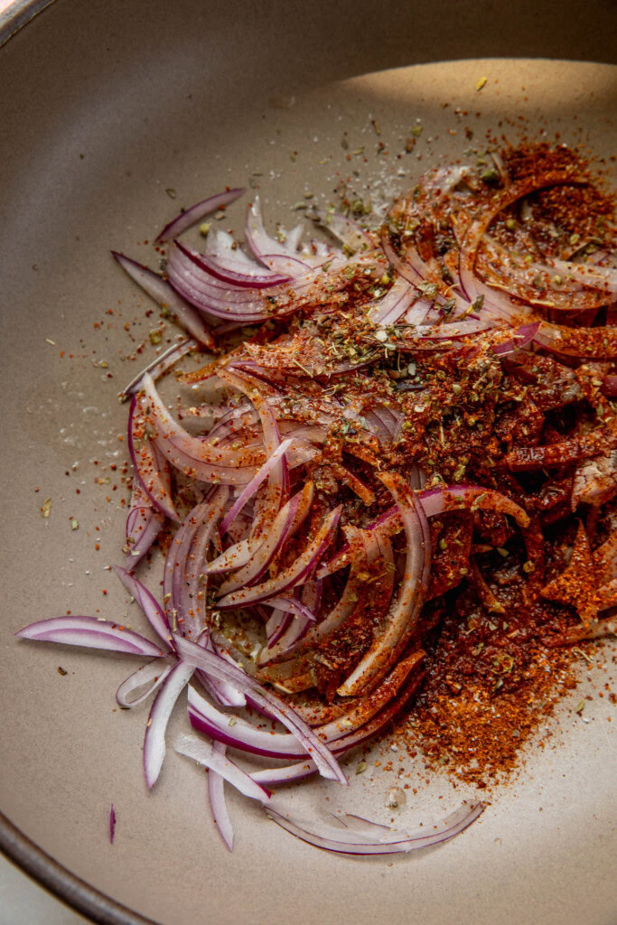 Onions topped with seasonings, oil, lemon, and salt.