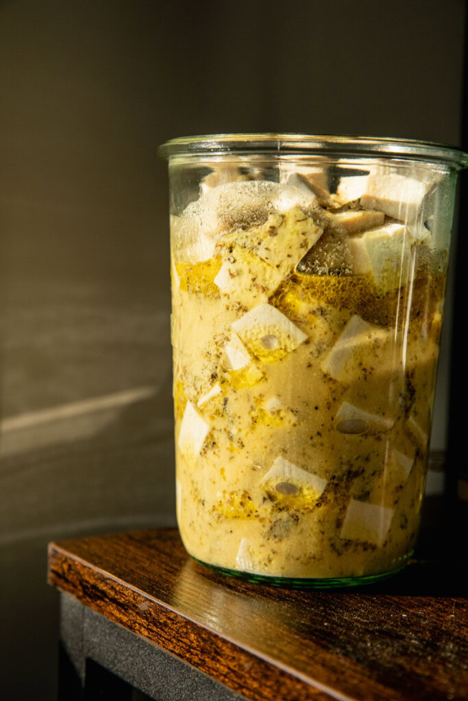 Topping the tofu with marinade.