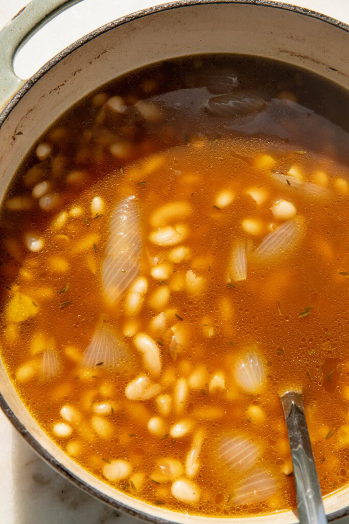 Cooked corn-simmered beans in a pot.