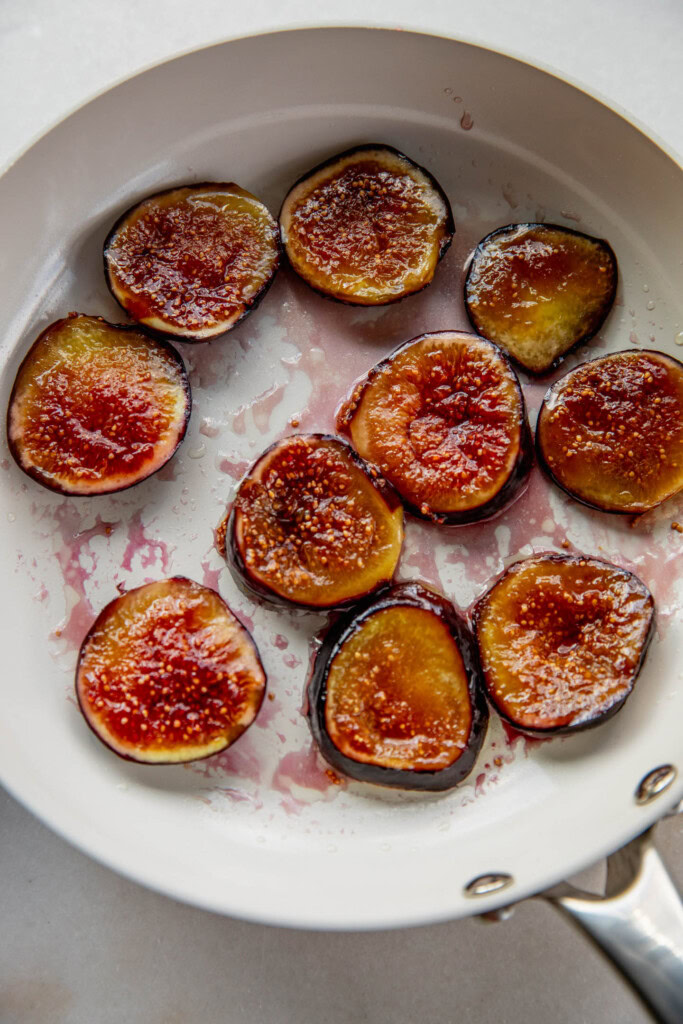 Caramelized figs in a pan.