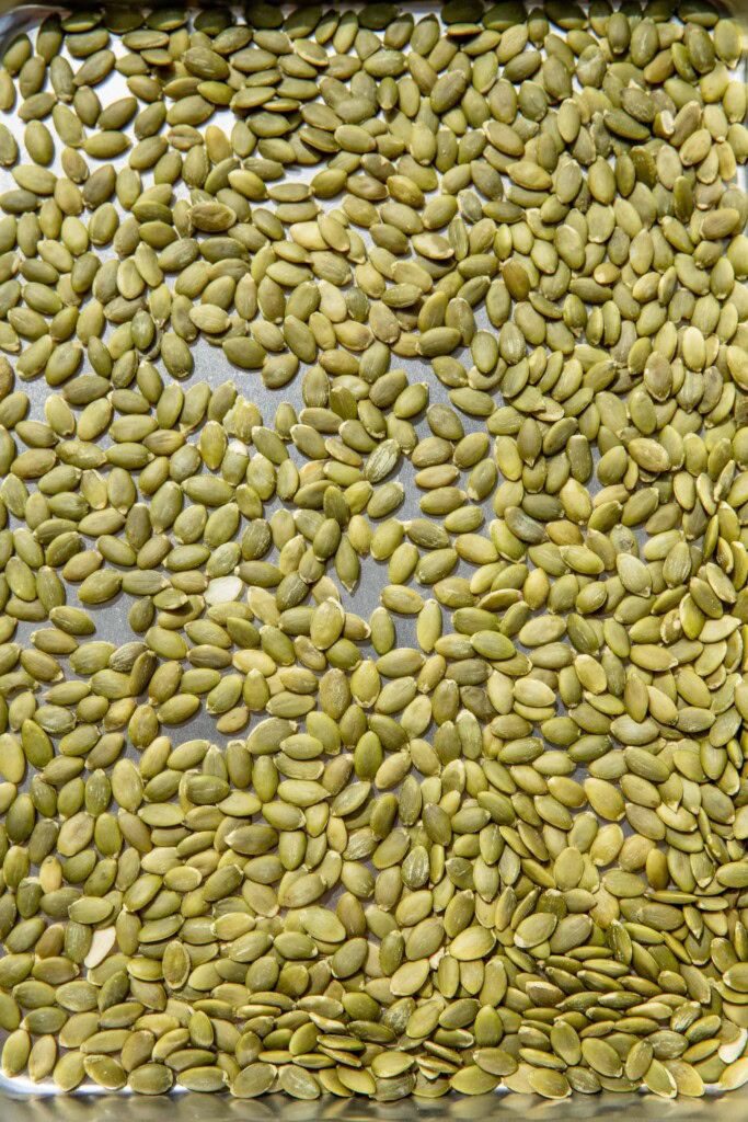 Pumpkin seeds on a baking tray.