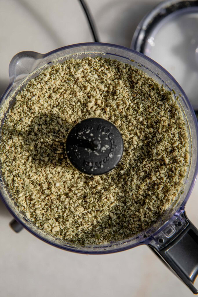 Pulverized pumpkin seeds in a food processor.