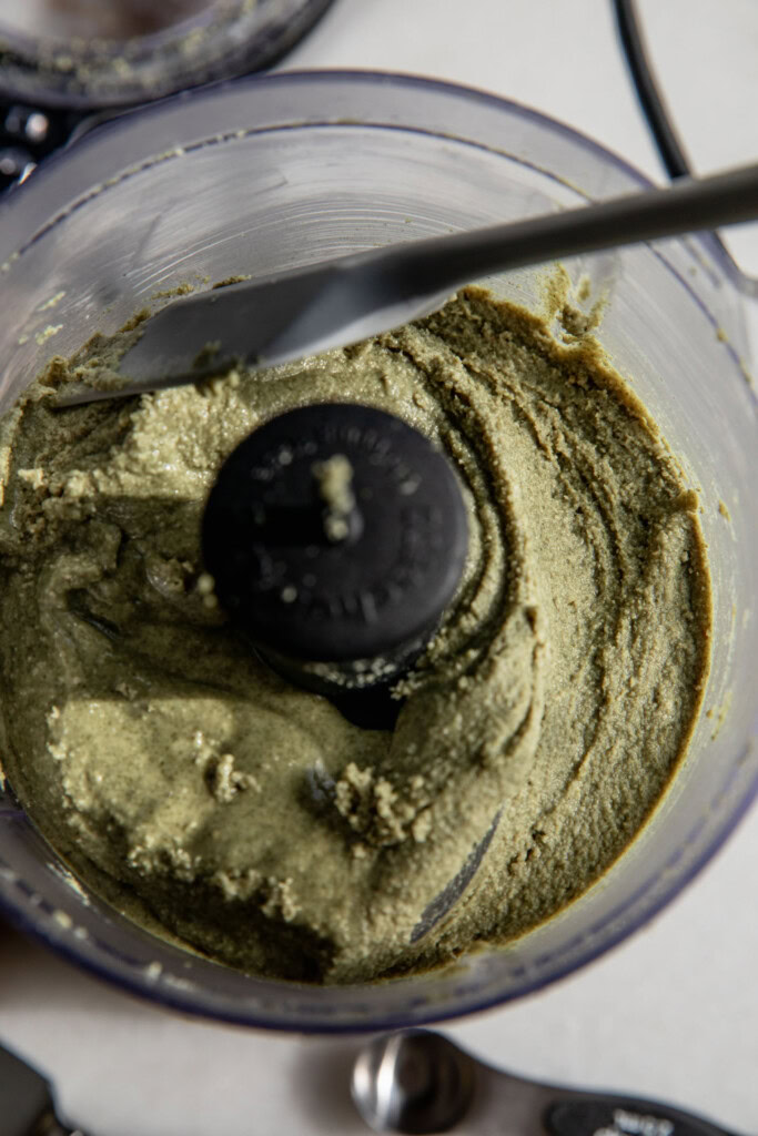 Oils starting to seperate from the pumpkin seed paste in a food processor.