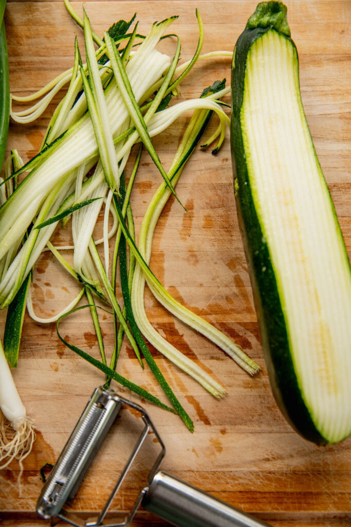 Shredded zucchini on cutting board.
