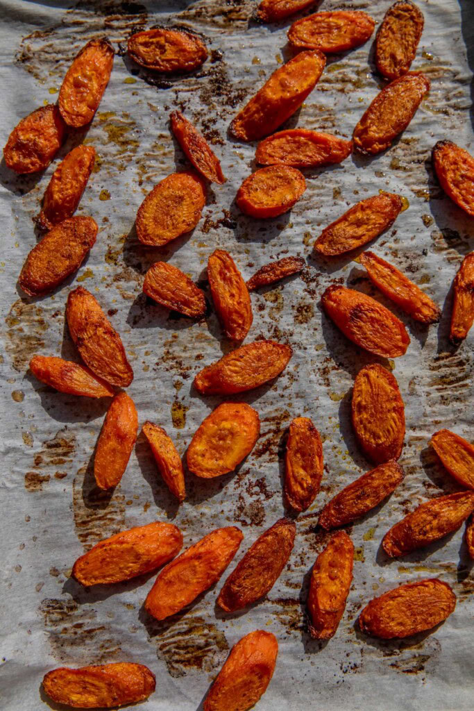 Caramelized roasted carrots on a baking sheet.
