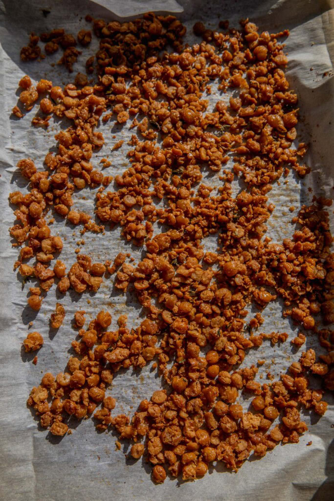 Crispy roughed up chickpeas on a baking sheet.
