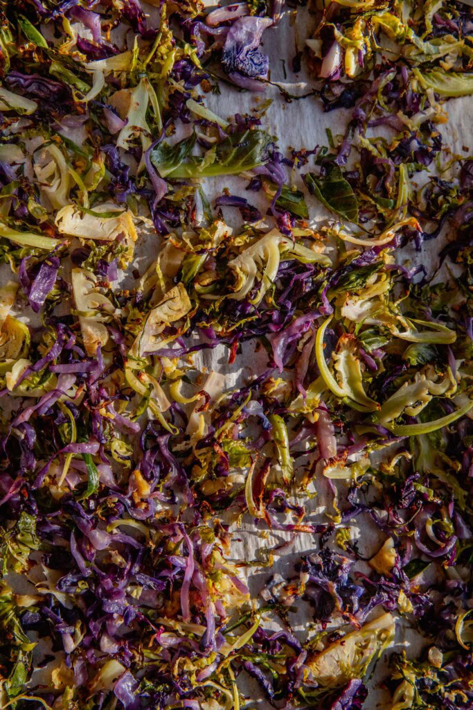 Caramelized cabbage and brussels sprouts on a baking tray.