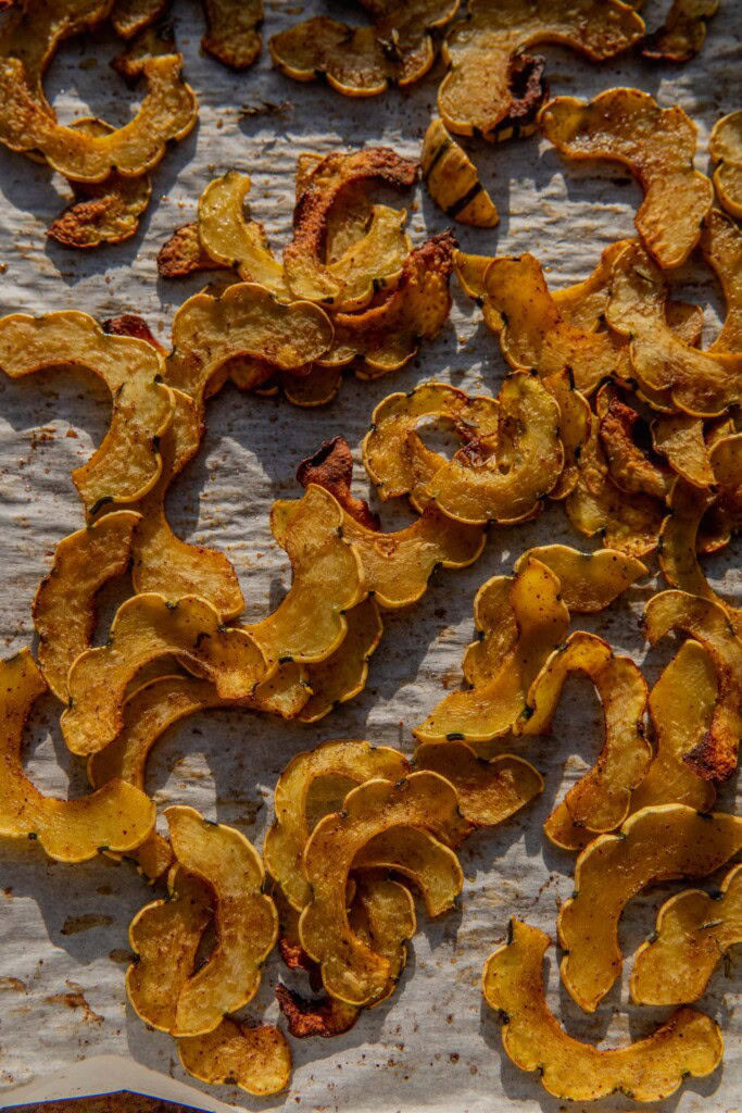 Roasted squash slices on a baking tray.