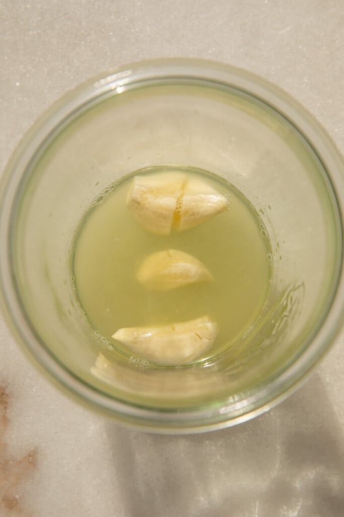 Jar with garlic and lemon juice.