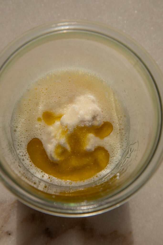 Jar with garlic, lemon juice, yogurt, mayo, and olive oil.