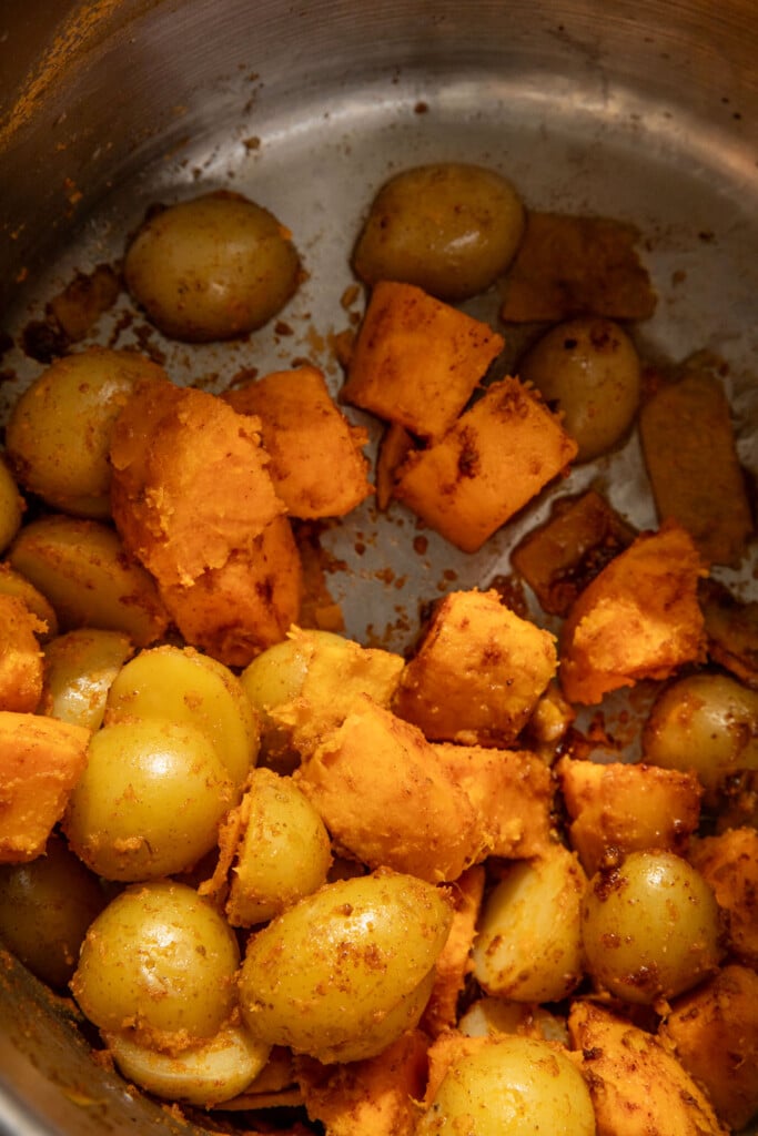 Roughed up potatoes in a pot.